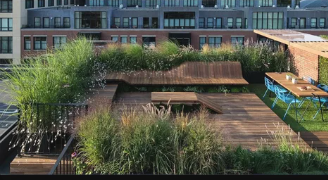Urban rooftop terrace with planting zones, dining setup, and soft natural materials